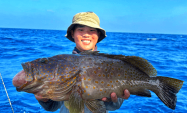 Bottom fishing at Tioman, Malaysia. Grouper (gao) caught using jig at coral reef spot.